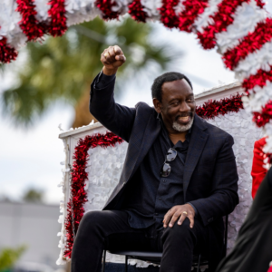 Mayor Demings waving to the crowd from a float in a holiday parade.