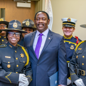 Mayor Demings standing with orange county sheriffs at an event in orange county florida.