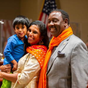 Mayor Demings with a mother and child at an orange county event.