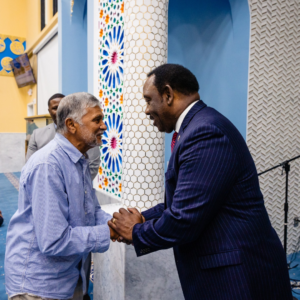 Mayor Demings shaking an attendee's hand at a Muslim cultural event in orange county florida.