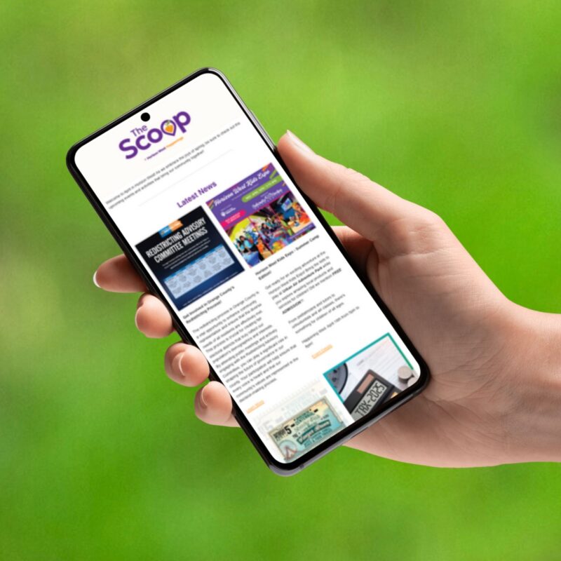 A hand holding a mobile phone with the Horizon West Happenings logo on it.