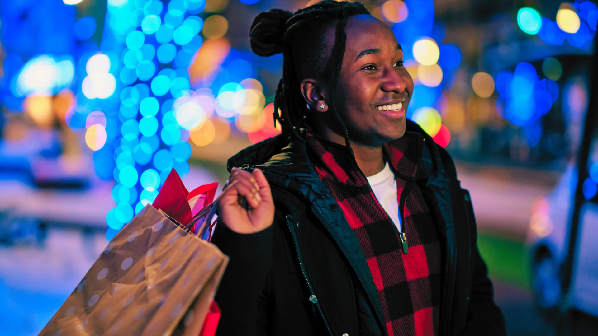 Young man with bags of gifts for the holidays